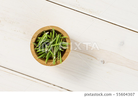 Fresh rosemary herb on grey wood 55604307