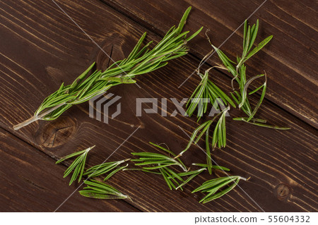 Fresh rosemary herb on brown wood 55604332