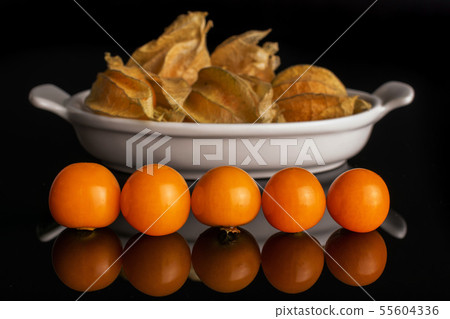 Fresh orange physalis isolated on black glass 55604336