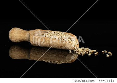 Unpeeled sesame seeds isolated on black glass 55604413
