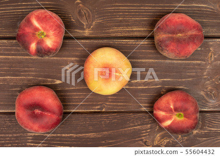 Fresh paraguay peach on brown wood Fresh paraguay peach on brown wood 55604432
