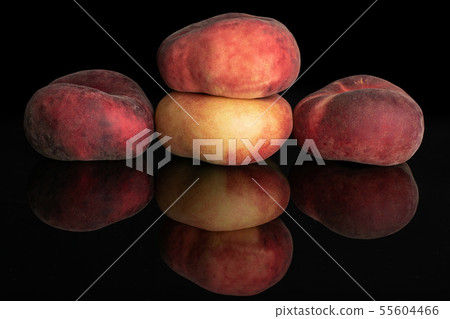 Fresh paraguay peach isolated on black glass Fresh paraguay peach isolated on black glass 55604466