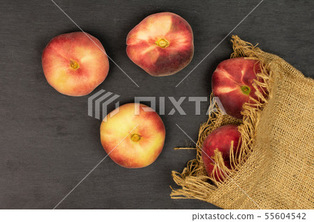 Fresh paraguay peach on grey stone Fresh paraguay peach on grey stone 55604542