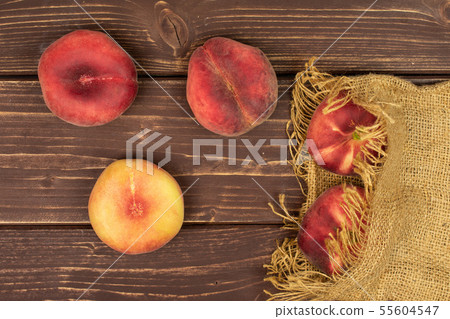 Fresh paraguay peach on brown wood Fresh paraguay peach on brown wood 55604547