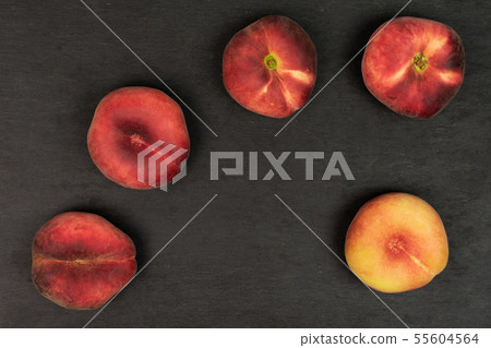 Fresh paraguay peach on grey stone Fresh paraguay peach on grey stone 55604564