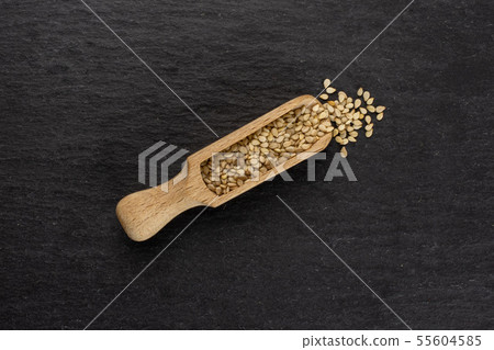 Unpeeled sesame seeds on grey stone 55604585