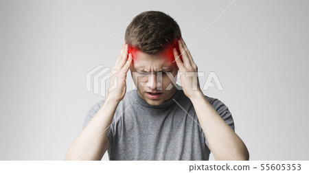 Young man suffering from headache after hard working day 55605353