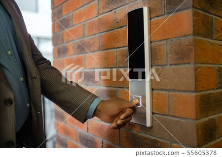 Young businessman wearing striped jacket pressing button 55605378