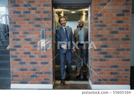 Two business partners entering business center while having meeting 55605384
