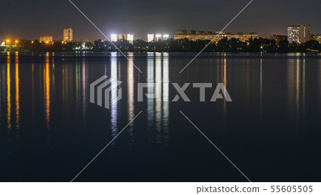 Skyline panorama of night city with lights reflection over water 55605505