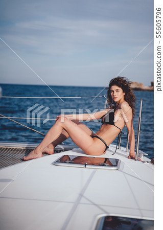 Fashion outdoor photo of beautiful young woman posing on a yachts 55605796