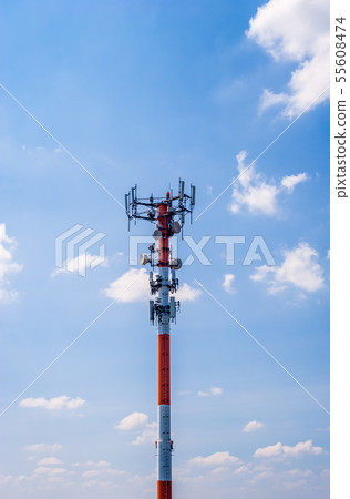 Thick red and white antenna on blue sky. Thick red and white antenna on blue sky. 55608474