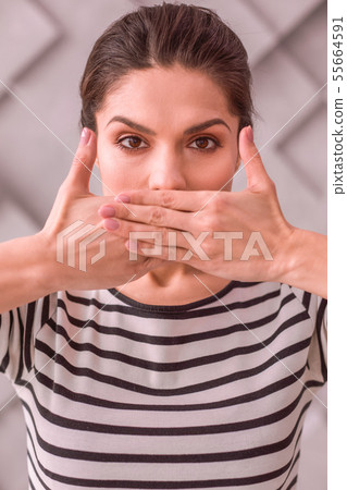 Woman trying not to tell something to others 55664591