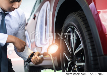 Asian man car inspection Measure quantity Inflated 55667866