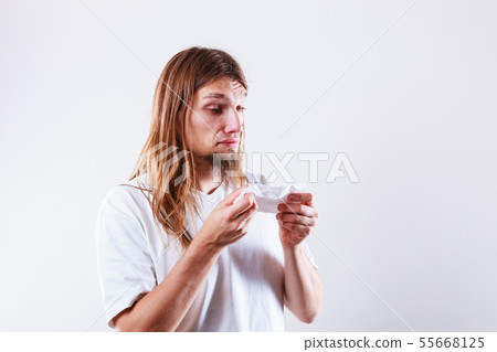 Man with hygienic tissue Man with hygienic tissue 55668125