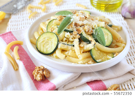 Italian penne pasta with roasted zucchini, cheese 55672350