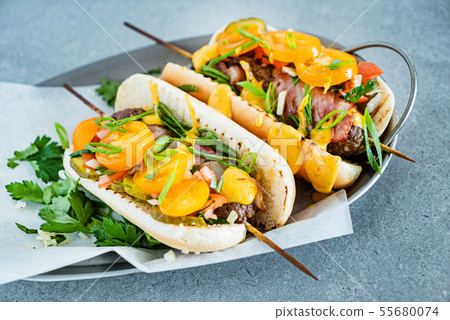 hot dogs with kebabs and vegetables 55680074