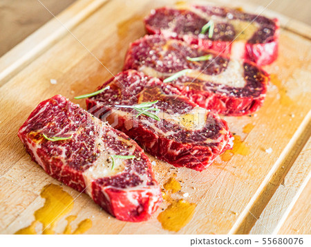 Large Raw Meat Steaks On Table 55680076