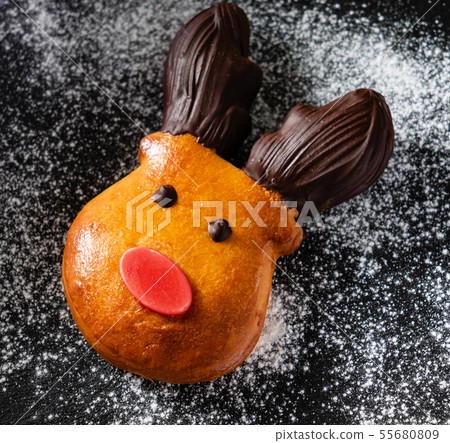 brioche deer with red nose and chocolate horns, Christmas bake 55680809
