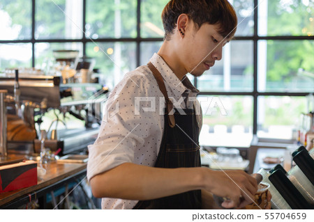Asian barista at work during making coffee, 55704659