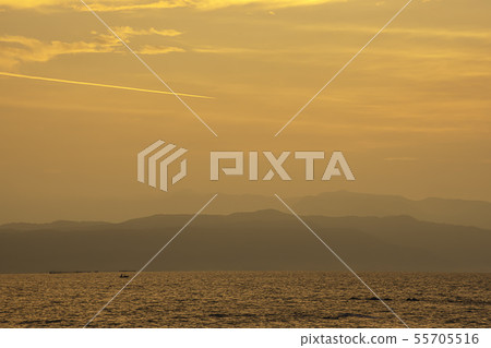 Golden light of sunrise behind the mountains. Golden light of sunrise behind the mountains. 55705516