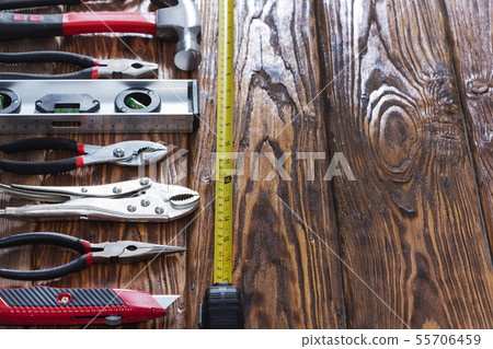 Close up tools on a wooden background. Close up tools on a wooden background. 55706459