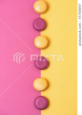 colorful french macarons on yellow with pink background colorful french macarons on yellow with pink background 55708997