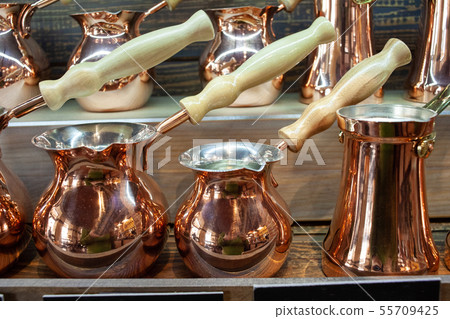 Various cezves in a shop window. Various cezves in a shop window. 55709425