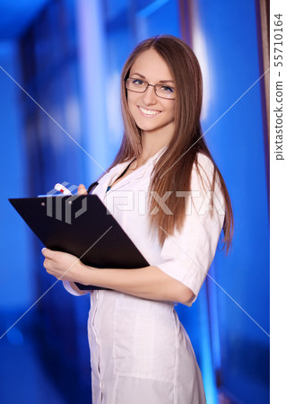 Medicine. Closeup portrait of a smiling, confident female doctor, healthcare professional with Medicine. Closeup portrait of a smiling, confident female doctor, healthcare professional with 55710164