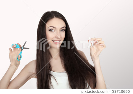 Portrait Of Beautiful Smiling Woman Holding Cigarette And Scissors In Hands. Quit Smoking Cigarettes Portrait Of Beautiful Smiling Woman Holding Cigarette And Scissors In Hands. Quit Smoking Cigarettes 55710690
