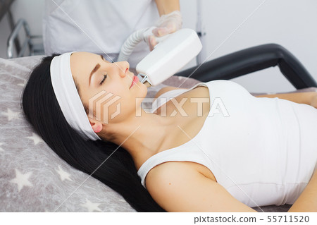 Cosmetology. Procedure of Microdermabrasion. Mechanical Exfoliation, diamond polishing. Model and Cosmetology. Procedure of Microdermabrasion. Mechanical Exfoliation, diamond polishing. Model and 55711520