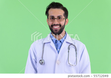 Face of happy young bearded Persian man doctor smiling 55712049