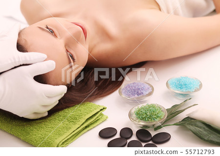 Spa. Care Facial. Beauty young woman gets a head massage in the salon Spa. Care Facial. Beauty young woman gets a head massage in the salon 55712793