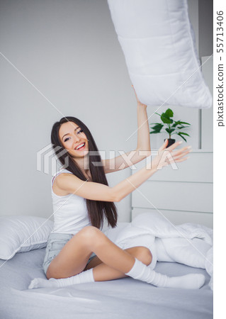 Relaxing On Bed During Weekend. Beautiful Woman Relaxing on a Bed and Looking Happy Relaxing On Bed During Weekend. Beautiful Woman Relaxing on a Bed and Looking Happy 55713406