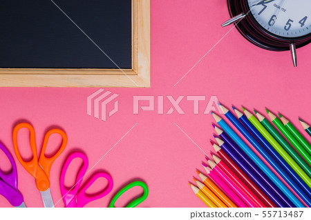 Back to school concept. Black wooden chalkboard. School supplies on pink background 55713487