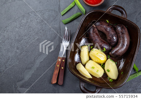 Chilean bloody sausages PRIETA with potatoes and sauce, Top View Chilean bloody sausages PRIETA with potatoes and sauce, Top View 55715934