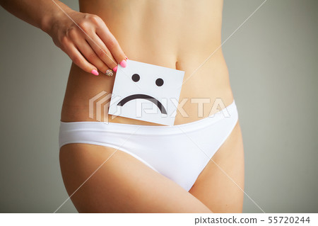 Woman Health Problem. Closeup Of Female With Fit Slim Body In Panties Holding White Card With Sad 55720244