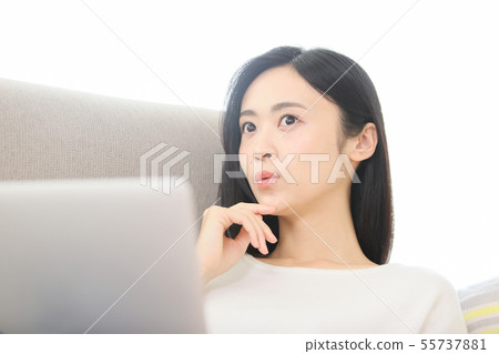 A young lady watching a computer 55737881
