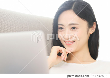 A young lady watching a computer 55737898