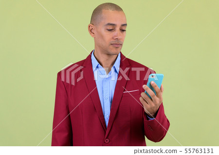Handsome bald multi ethnic businessman using phone 55763131