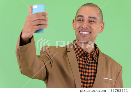 Happy bald multi ethnic businessman taking selfie Happy bald multi ethnic businessman taking selfie 55763531