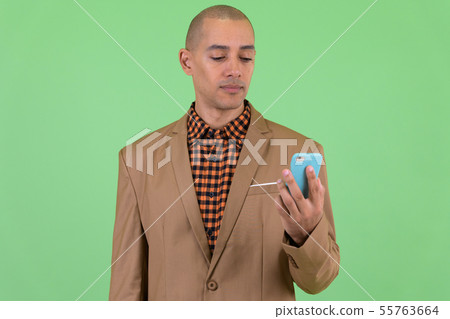 Handsome bald multi ethnic businessman using phone Handsome bald multi ethnic businessman using phone 55763664