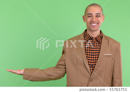 Happy bald multi ethnic businessman showing something 55763753