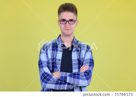 Young handsome hipster man with arms crossed Young handsome hipster man with arms crossed 55766573
