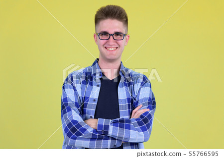 Happy young handsome hipster man smiling with arms crossed Happy young handsome hipster man smiling with arms crossed 55766595