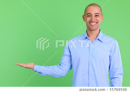 Happy bald multi ethnic businessman showing something Happy bald multi ethnic businessman showing something 55769598