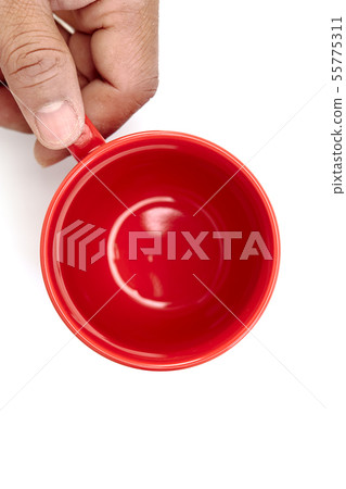 Top view hand holding empty red mug coffee Top view hand holding empty red mug coffee 55775311