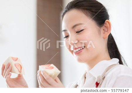 Female fruit sandwich 55779147