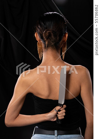 Asian Woman long hair hold Kitchen Knife in hand 55786862