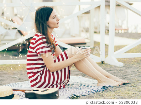 brunette girl on a picnic with garlands brunette girl on a picnic with garlands 55800038